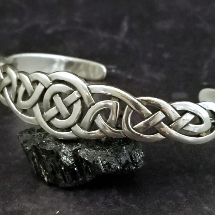 An intricate openwork Celtic weave design in all sterling silver cuff. Wear alone, or stack with some simpler designs for an bold look.