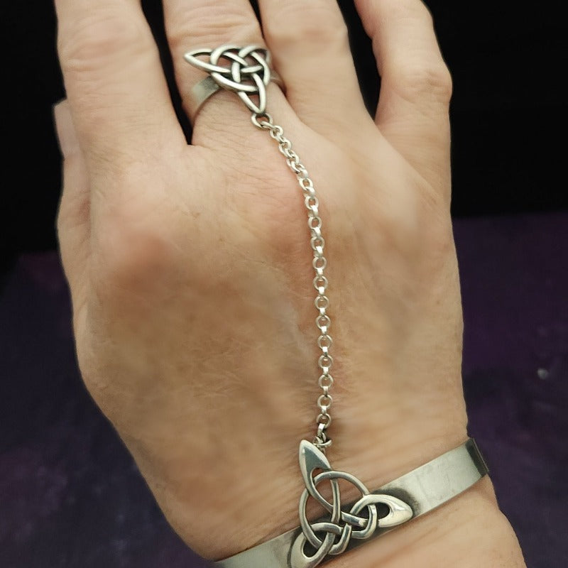 This traditional classic CELTIC DANCE cuff, adorned with a sterling Triquetra Knot, pays homage to the spirited nights of Celtic music and dancing. Its robust design ensures a lifetime of use, while the polished sterling silver offers a lustrous shine that never fades. This timeless piece of Celtic jewelry is sure to be a conversation starter.