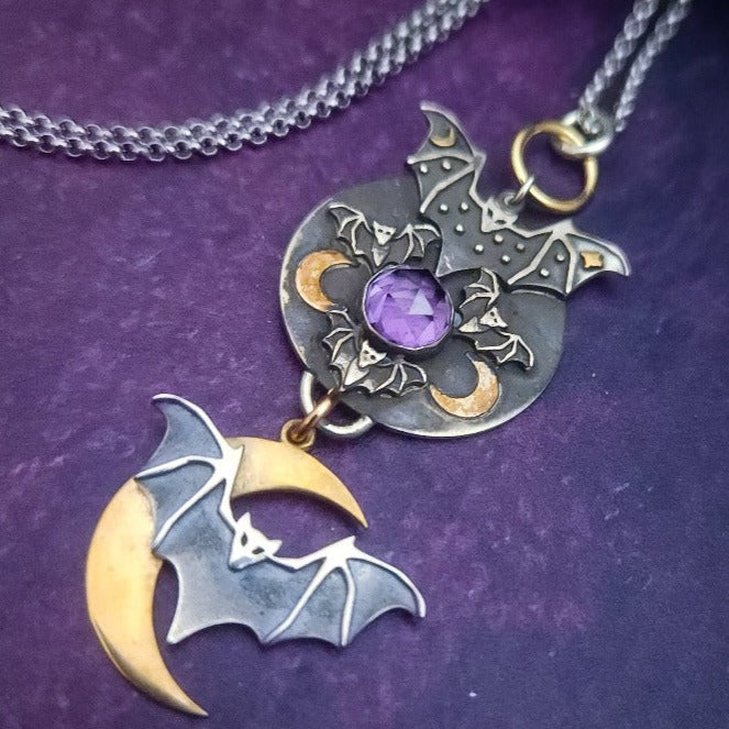 A gothic inspired pendant with a rose cut amethyst set in a haven of bats in flight. By My Secret Heart Studios