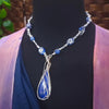 DEEP BLUE like midnight skies and ocean depths.  This asymmetrical collar necklace is a testament to artisan craftsmanship and design. The Lapis Lazuli Cabochon is encased in a Wire Wrapped setting with a beautifully fluid look, And the gemstones are embellished with sterling silver adding a unique look.