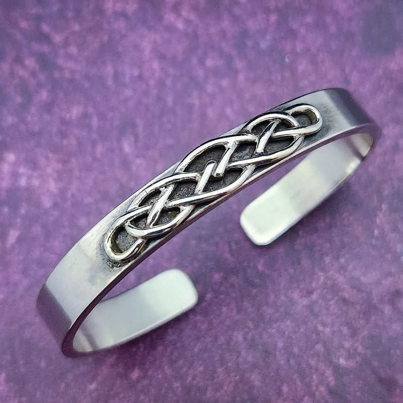 CADMAN CUFF, Timeless and classic, this Celtic-inspired sterling silver cuff boasts a sleek, minimalistic front, reminiscent of medieval times.