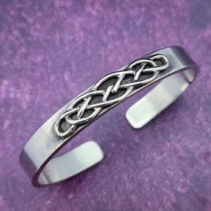 CADMAN CUFF, Timeless and classic, this Celtic-inspired sterling silver cuff boasts a sleek, minimalistic front, reminiscent of medieval times.