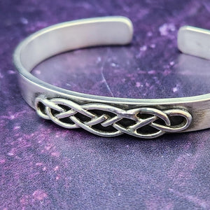 CADMAN CUFF, Timeless and classic, this Celtic-inspired sterling silver cuff boasts a sleek, minimalistic front, reminiscent of medieval times.