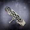The Cadman Key Keeper Cuff features a chain with a detachable clasp that holds the key to the submissive's lock. With these unique jewelry clasps, the key chain removal is quick and convenient - the key chain can even be linked to a collar during play. Crafted from sterling silver, these luxurious pieces add a sophisticated flair to BDSM boudoirs. By My Secret Heart Studios