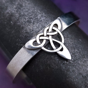 This traditional classic CELTIC DANCE cuff, adorned with a sterling Triquetra Knot, pays homage to the spirited nights of Celtic music and dancing. Its robust design ensures a lifetime of use, while the polished sterling silver offers a lustrous shine that never fades. This timeless piece of Celtic jewelry is sure to be a conversation starter.