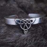 This traditional classic CELTIC DANCE cuff, adorned with a sterling Triquetra Knot, pays homage to the spirited nights of Celtic music and dancing. Its robust design ensures a lifetime of use, while the polished sterling silver offers a lustrous shine that never fades. This timeless piece of Celtic jewelry is sure to be a conversation starter.
