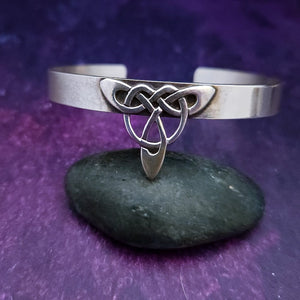 This traditional classic CELTIC DANCE cuff, adorned with a sterling Triquetra Knot, pays homage to the spirited nights of Celtic music and dancing. Its robust design ensures a lifetime of use, while the polished sterling silver offers a lustrous shine that never fades. This timeless piece of Celtic jewelry is sure to be a conversation starter.
