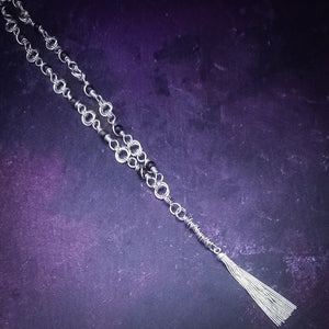 Adorn yourself with this beautiful handcrafted silver and onyx chain that can be transformed into stylish handcuffs and ankle restraints, a chic locking collar, or a gemstone necklace for Dominants. Connect it to the back of a collar for a sexy look, and give a tug on the chain for an extra choking sensation. Includes a Flogger Pendant in sterling silver and a gemstone O Ring Slide with Rose Cut Black Onyx. With its versatile appeal, This CONVERSION CHAIN will certainly be a beloved accessory!