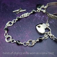 Adorn yourself with this beautiful handcrafted silver and onyx chain that can be transformed into stylish handcuffs and ankle restraints, a chic locking collar, or a decorative necklace for Dominants. Connect it to the back of a collar for a sexy look, and give a tug on the chain for an extra choking sensation. With its versatile appeal, CONVERSION CHAIN, BLACK ONYX & STERLING will certainly be a beloved accessory! By My Secret Heart Studios