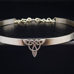 This BDSM Locking Submissive CELTIC DANCE collar is adorned with a sterling Triquetra Knot and pays homage to the spirited nights of Celtic music and dancing. Its robust design ensures a lifetime of use, while the polished sterling silver offers a lustrous shine that never fades. This timeless piece of Celtic jewelry is sure to be a conversation starter. By My Secret Heart Studios