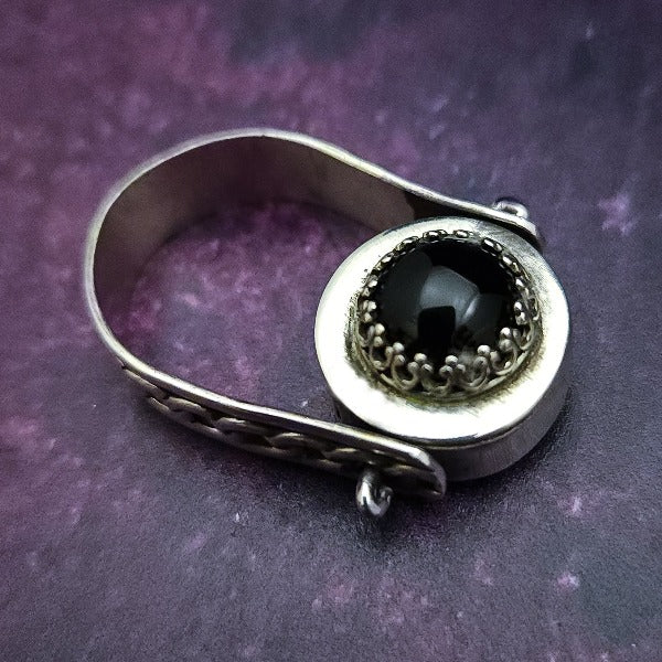 ONE OF A KIND  Two in One Reversible Flip Ring  Change your mind. Change your mood. Completely handcrafted. The design spins, so just flip it around for a different look.  SIDE ONE: Sterling silver Celtic tryptic knot  SIDE TWO: Sterling Silver with Black Onyx set into filigree bezel. By My Secret Heart Studios