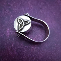 ONE OF A KIND  Two in One Reversible Flip Ring  Change your mind. Change your mood. Completely handcrafted. The design spins, so just flip it around for a different look.  SIDE ONE: Sterling silver Celtic tryptic knot  SIDE TWO: Sterling Silver with Black Onyx set into filigree bezel. By My Secret Heart Studios