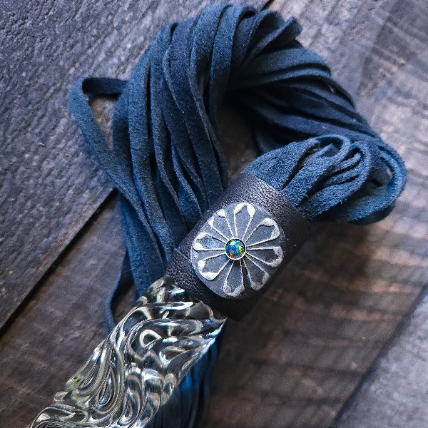 This limited edition Flogger, the Celtic Shield, is graced with a striking black and silver medallion full of mystic and heritage, showcasing a Celtic Shield and set with a Black Opal. For the 2023 holidays, only 7 of these have been created! Hurry and get yours now. Ready To Ship!