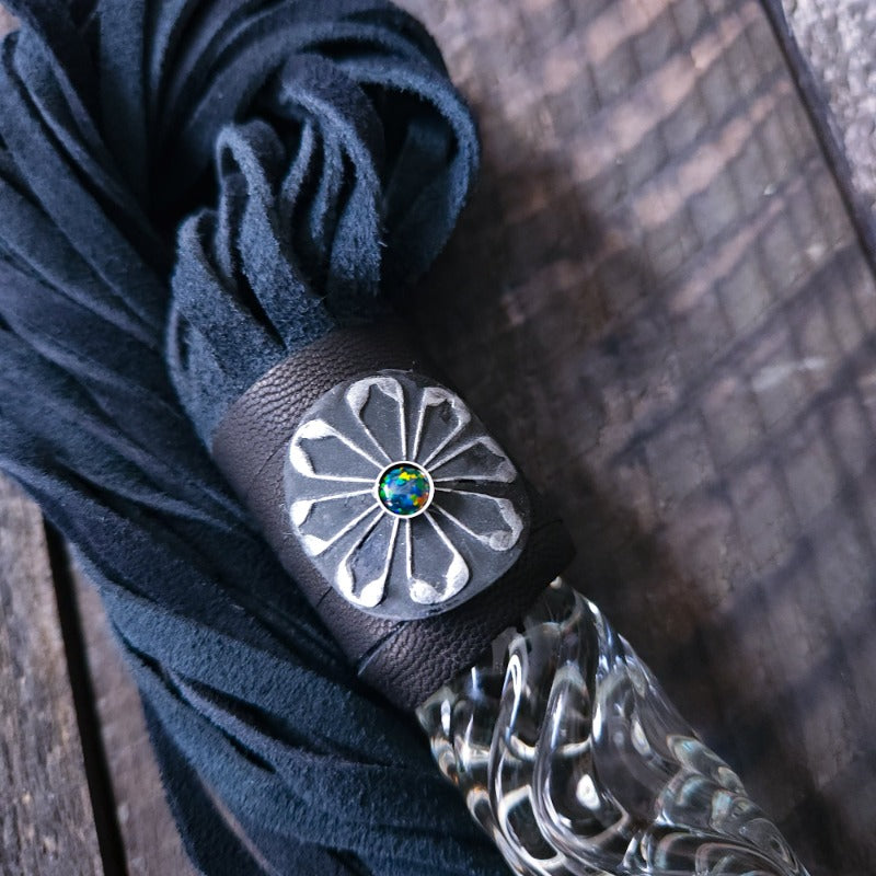 This limited edition Flogger, the Celtic Shield, is graced with a striking black and silver medallion full of mystic and heritage, showcasing a Celtic Shield and set with a Black Opal. For the 2023 holidays, only 7 of these have been created! Hurry and get yours now. Ready To Ship!