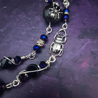 Crafted with My Secret Heart's exquisite and discreet grace, this one-of-a-kind design combines dark and creepy fashion with an air of submissive mystery. Decorated with sterling silver spiders and beetles, black onyx, and midnight Iris crystals, this exquisite locking kitten bell will surely make your kitten stand out.