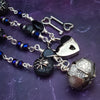 Crafted with My Secret Heart's exquisite and discreet grace, this one-of-a-kind design combines dark and creepy fashion with an air of submissive mystery. Decorated with sterling silver spiders and beetles, black onyx, and midnight Iris crystals, this exquisite locking kitten bell will surely make your kitten stand out.