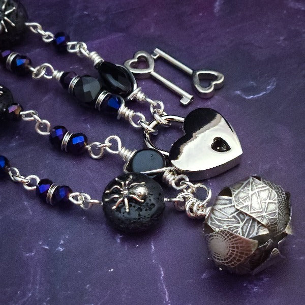 Crafted with My Secret Heart's exquisite and discreet grace, this one-of-a-kind design combines dark and creepy fashion with an air of submissive mystery. Decorated with sterling silver spiders and beetles, black onyx, and midnight Iris crystals, this exquisite locking kitten bell will surely make your kitten stand out.