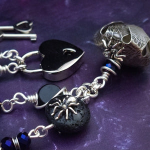 Crafted with My Secret Heart's exquisite and discreet grace, this one-of-a-kind design combines dark and creepy fashion with an air of submissive mystery. Decorated with sterling silver spiders and beetles, black onyx, and midnight Iris crystals, this exquisite locking kitten bell will surely make your kitten stand out.