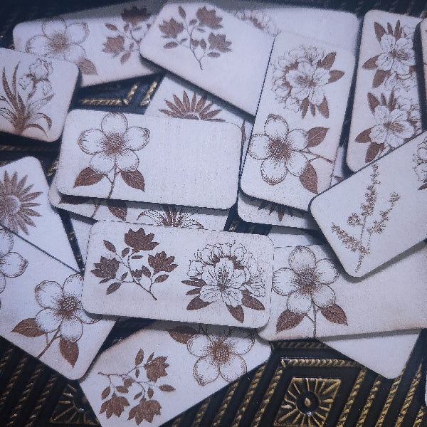 Set of wooden dominos with floral designs on a textured surface