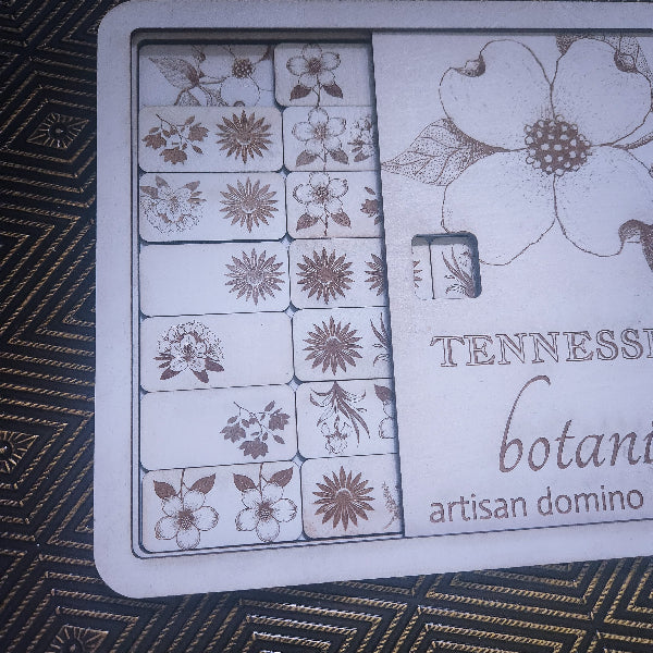 Floral dominoes game set with 'Tennessee Botanicals' branding on a textured surface.