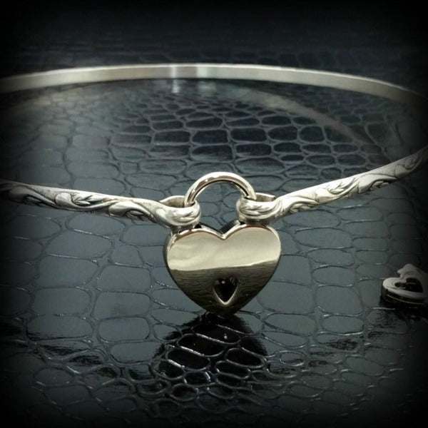 The 'INFATUATION' collection of submissive jewelry is sweetly feminine. Delicate with a soft flowing design that's perfect for todays sub, yet has a medieval touch to it. This submissive locking collar is hand crafted in a romantic floral pattern of solid sterling silver. A beautiful symbol of commitment or wedding gift.