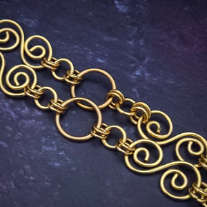 Infinity Conversion Collar. This exquisite piece, meticulously crafted with links of opulent gold filled wire, features a central link specifically designed to hold our stunning Wire Wrapped Gemstone Pendants.