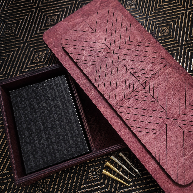 Inside top of Teak stained Cribbage Box with geometric pattern on a matching box, open to reveal a black cardholder and gold pegs.
