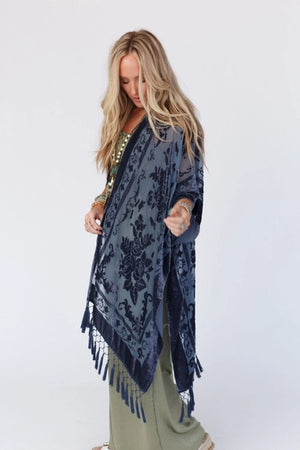 Get ready to turn heads in this chic kimono! The luxurious velvet and mesh combo is sure to make a statement and the playful tassels add a touch of flirty fun. Pair it with your go-to basics for an effortlessly stylish ensemble!