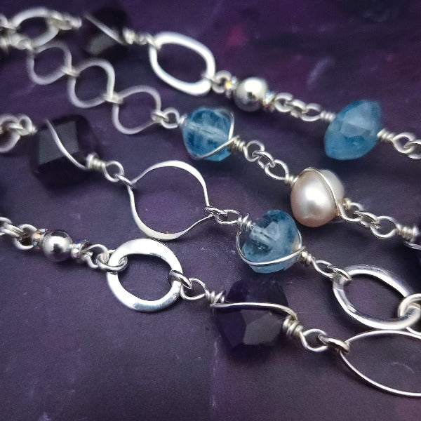 Crafted with My Secret Heart's signature grace and discretion, our locking submissive kitten bell is a one-of-a-kind design. Embellished with dazzling sterling silver, Aquamarine nuggets, Amethyst gems, and Freshwater Pearls, this exquisite and eye-catching collar will make your kitten stand out! 