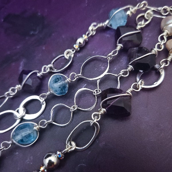  Crafted with My Secret Heart's signature grace and discretion, our locking submissive kitten bell is a one-of-a-kind design. Embellished with dazzling sterling silver, Aquamarine nuggets, Amethyst gems, and Freshwater Pearls, this exquisite and eye-catching collar will make your kitten stand out! 