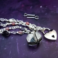 An original, one of a kind design, our locking submissive kitten bell is handcrafted with all the grace and discretion that My Secret Heart is known for. Wear this as a fashion piece or as a subtle submissive or pet play collar, either way you will look amazing!  Crafted in luxurious sterling silver and embellished with pretty pink Rhodochrosite, Amethyst nuggets, pearls and stardust beads, this will make your kitten feel so pretty!  By My Secret Heart Studios