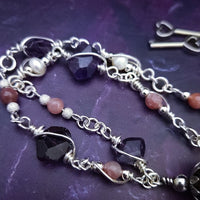 An original, one of a kind design, our locking submissive kitten bell is handcrafted with all the grace and discretion that My Secret Heart is known for. Wear this as a fashion piece or as a subtle submissive or pet play collar, either way you will look amazing!  Crafted in luxurious sterling silver and embellished with pretty pink Rhodochrosite, Amethyst nuggets, pearls and stardust beads, this will make your kitten feel so pretty!  By My Secret Heart Studios