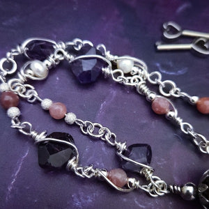 An original, one of a kind design, our locking submissive kitten bell is handcrafted with all the grace and discretion that My Secret Heart is known for. Wear this as a fashion piece or as a subtle submissive or pet play collar, either way you will look amazing!  Crafted in luxurious sterling silver and embellished with pretty pink Rhodochrosite, Amethyst nuggets, pearls and stardust beads, this will make your kitten feel so pretty!  By My Secret Heart Studios