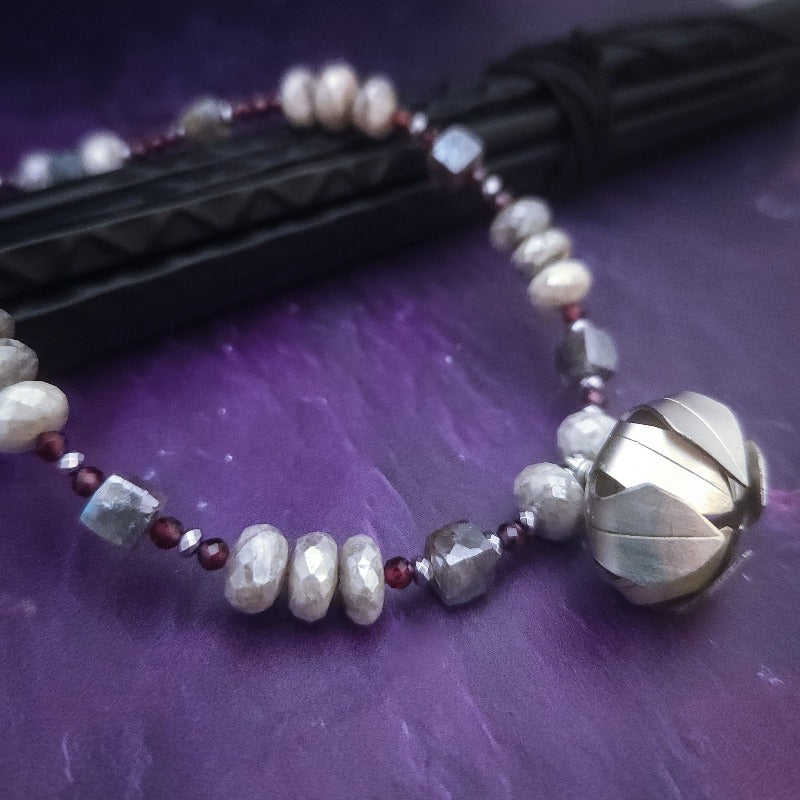 Rich Moonstone, Labradorite and Ruby glisten to give this piece a look of luxury, guaranteed to make your kitten purr with delight! An original, one of a kind design, our locking submissive kitten bell is handcrafted with all the grace and discretion that My Secret Heart is known for. Wear this as a fashion piece or as a subtle submissive or pet play collar, either way you will look amazing! 