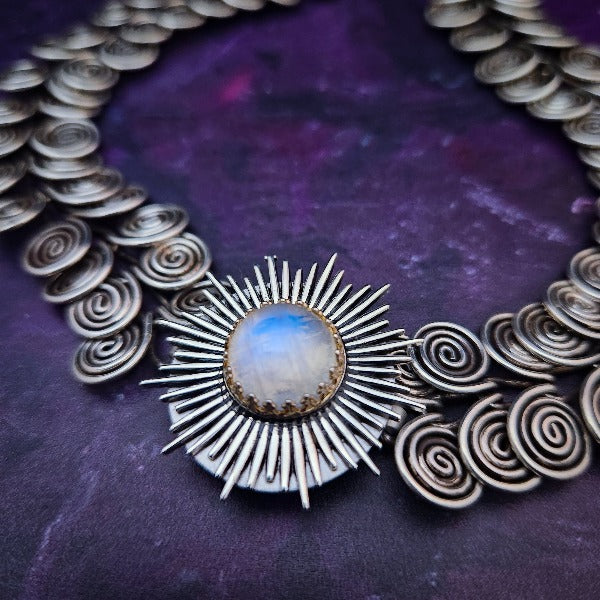 The KYRO INTERCHANGEABLE MEDALLIONS are created to wear on the KYRO COLLARS and can be effortlessly changed. In a heartbeat, you can transform a collar from gothic to girly, uptown to downtown, or casual to dramatic. This one is sterling STARBURST with RAINBOW MOONSTONE. By My Secret Heart Studios.