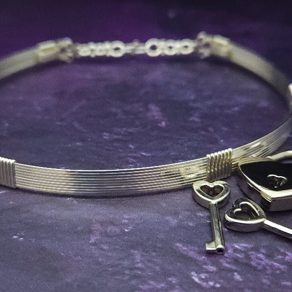 Our LODI Wire Wrapped Submissive Collars add a luxurious and seductive touch to your BDSM wardrobe. Handcrafted with 14K gold filled or sterling silver, these artisan collars lock shut for a secure and stylish look. Add luxury to your lifestyle with LODI by My Secret Heart Studios