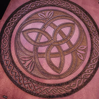 Decorative game with engraved celtic circles on a teak stain wood 