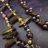 Make a bold statement with MARNIA, the one-of-a-kind necklace featuring titanium druzy, freshwater pearls, and a handcrafted bronze medallion ammonite. Turn heads with the vibrant colors and asymmetrical design, guaranteed to make you look and feel unforgettable!