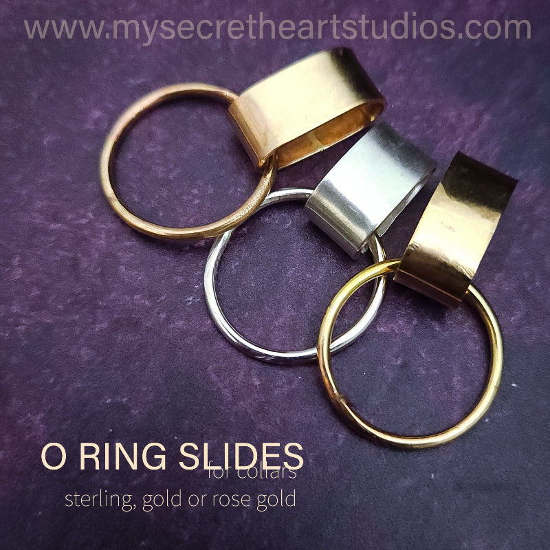 Gold and silver O ring slides on a purple background with website text.