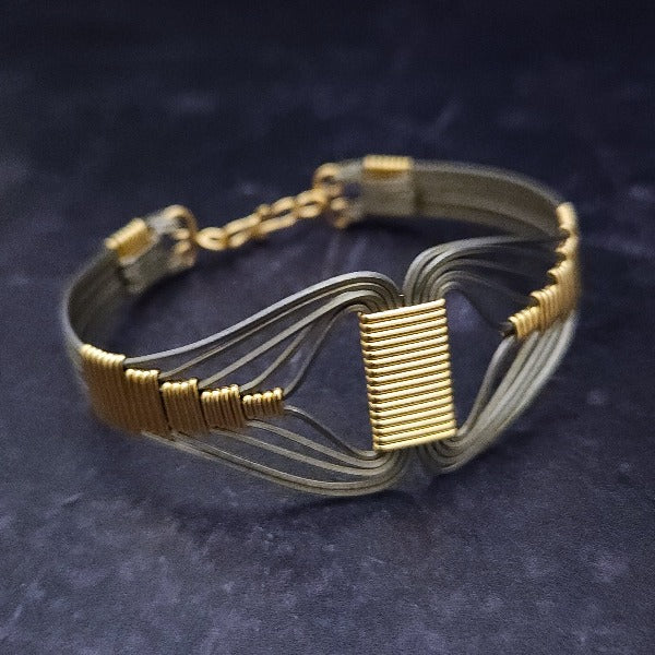 A modern twist on classic royalty, the CLEO Locking Cuff Bracelet is a bold yet discreet tribute to the powerful Egyptian Queen. Wrapped in titanium and accented with 14K gold filled details, it's an alluring and timeless statement piece.