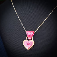 Revamp your locks with a touch of style. This locking soft chain collars features a small heart lock, adorned with a vibrant pink burst pattern and a sparkling center crystal. The embellished lock can also be worn with other collars and chains. Strut your ownership/submission in style ... never wear a plain ole' lock again!!