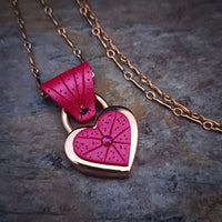 Revamp your locks with a touch of style. This locking soft chain collars features a small heart lock, adorned with a vibrant pink burst pattern and a sparkling center crystal. The embellished lock can also be worn with other collars and chains. Strut your ownership/submission in style ... never wear a plain ole' lock again!!