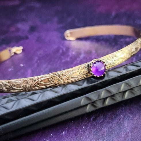Our Soft and Sweet submissive collar is the epitome of feminine grace. Handcrafted with loving care, this artisan-made 14k gold filled submissive collar radiates femininity with its floral sterling silver pattern and a hand-set 8mm Amethyst. Beautifully feminine and romantic.