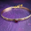 Our Soft and Sweet submissive collar is the epitome of feminine grace. Handcrafted with loving care, this artisan-made 14k gold filled submissive collar radiates femininity with its floral sterling silver pattern and a hand-set 8mm Garnet. Beautifully feminine and romantic.