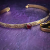 Our Soft and Sweet submissive collar is the epitome of feminine grace. Handcrafted with loving care, this artisan-made 14k gold filled submissive collar radiates femininity with its floral sterling silver pattern and a hand-set 8mm Garnet. Beautifully feminine and romantic.