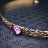 Our NEW GOLD & PINK SAPPHIRE Soft and Sweet submissive collar and cuffs are the epitome of feminine grace. Handcrafted with loving care, these artisan-made 14k gold filled submissive collars and cuffs radiate femininity with a floral pattern and a hand-set 8mm Natural Amethyst. Beautifully feminine and romantic.