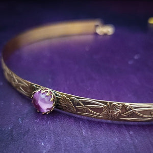 Our NEW GOLD & PINK SAPPHIRE Soft and Sweet submissive collar and cuffs are the epitome of feminine grace. Handcrafted with loving care, these artisan-made 14k gold filled submissive collars and cuffs radiate femininity with a floral pattern and a hand-set 8mm Natural Amethyst. Beautifully feminine and romantic.