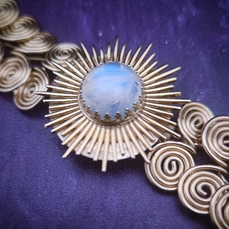 The KYRO INTERCHANGEABLE MEDALLIONS are created to wear on the KYRO COLLARS and can be effortlessly changed. In a heartbeat, you can transform a collar from gothic to girly, uptown to downtown, or casual to dramatic. This one is a 14K Gold Filled Starburst with Rainbow Moonstone by My Secret Heart Studios