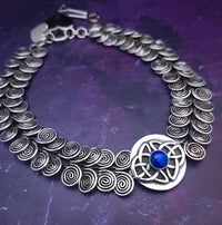 The KYRO INTERCHANGEABLE MEDALLIONS are created to wear on the KYRO COLLARS and can be effortlessly changed. In a heartbeat, you can transform a collar from gothic to girly, uptown to downtown, or casual to dramatic. Sterling Celtic Knot with Lapis. By My Secret Heart Studios.
