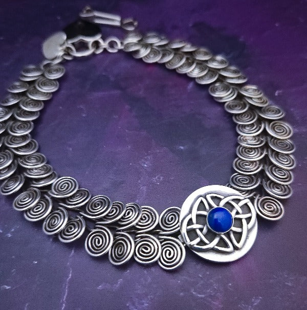 The KYRO INTERCHANGEABLE MEDALLIONS are created to wear on the KYRO COLLARS and can be effortlessly changed. In a heartbeat, you can transform a collar from gothic to girly, uptown to downtown, or casual to dramatic. Sterling Celtic Knot with Lapis. By My Secret Heart Studios.
